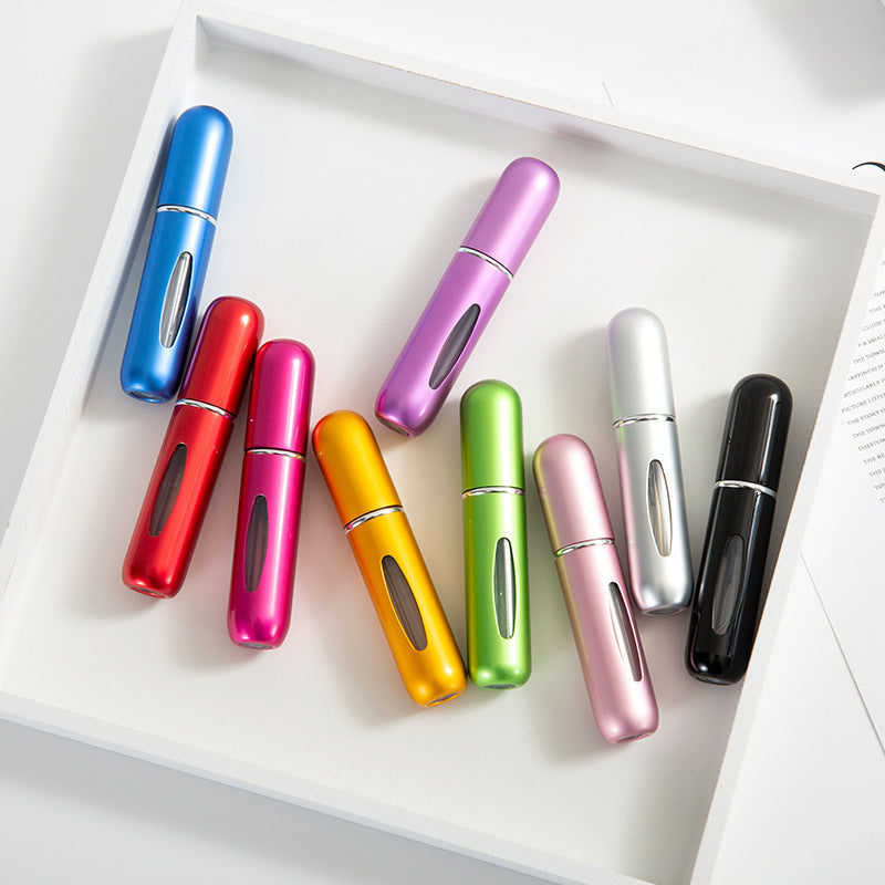 Assorted colorful 5ml refillable perfume atomizers displayed on tray
